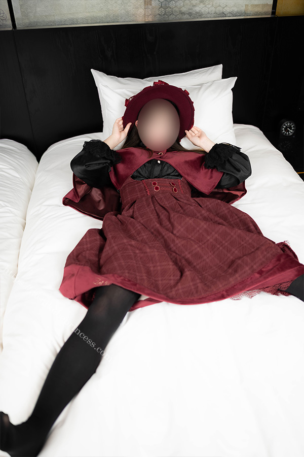 ロリータ服を著てベッドの上でポーズをとる女の子